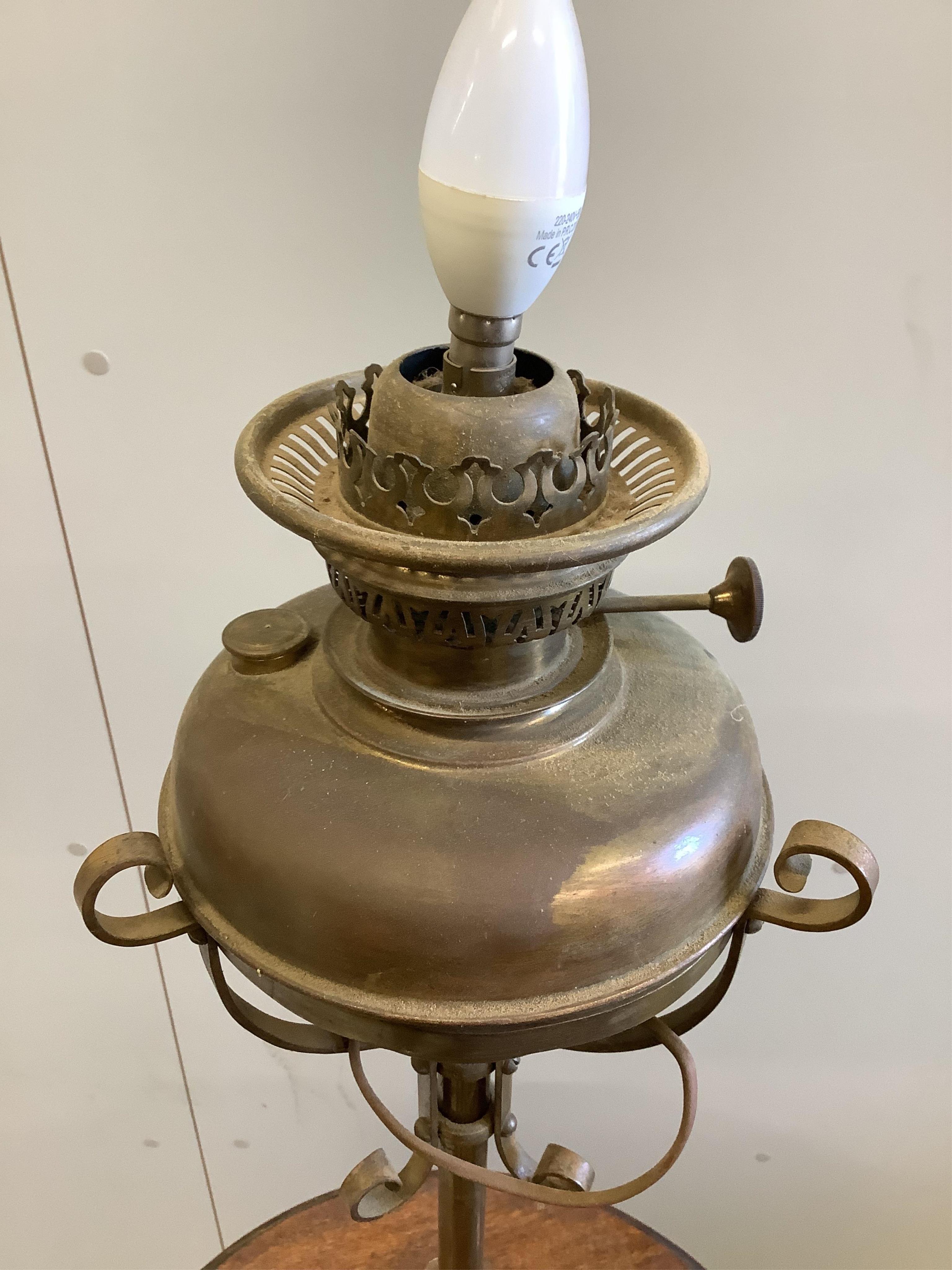 A late Victorian brass and oak telescopic oil lamp standard, converted to electricity, height 152cm